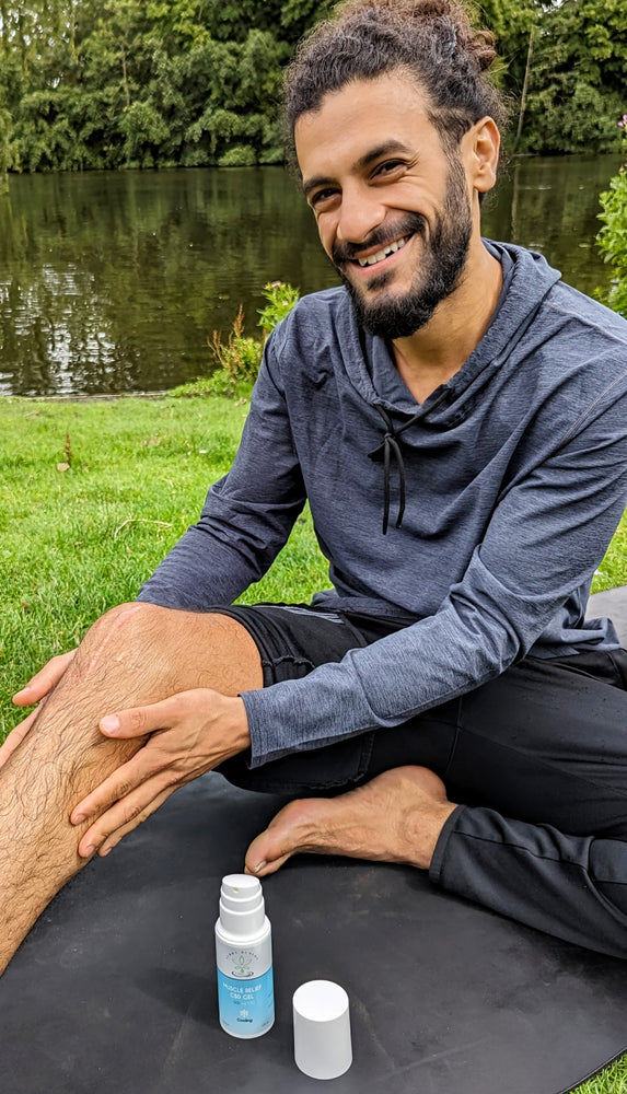 
                  
                    A person smiling after applying Terra Remedy Muscle Relief CBD Gel to their knee. The gel, with 500 mg of CBD, offers cooling relief for sore muscles and is ideal for post-workout recovery.
                  
                